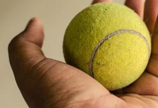 Tennis ball in hand