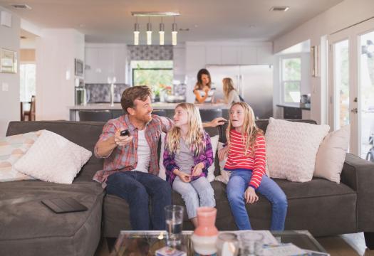 Family gathers on the couch to watch television