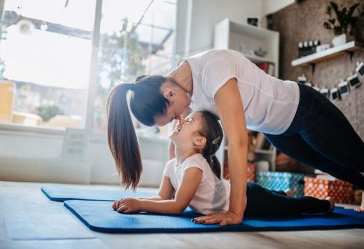 Mom and daughter doing yoga