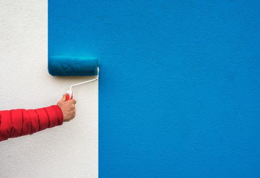 Hand painting a wall blue | Merry Maids