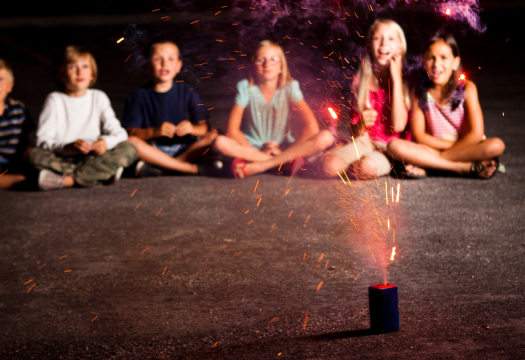 Kids sitting watching a sparkler | Merry Maids