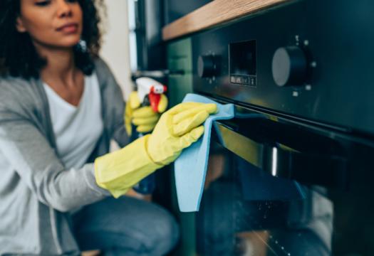 Women cleaning an oven | Merry Maids
