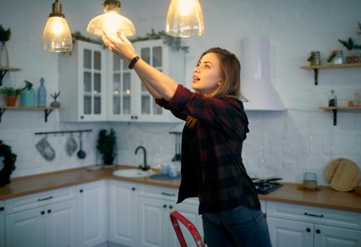 Woman changing lightbulb